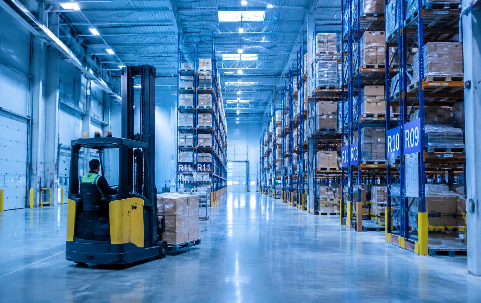 Forklift operator in a modern distribution warehouse